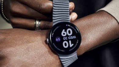 A hand pulling the stretchable strap on the Pixel Watch 4